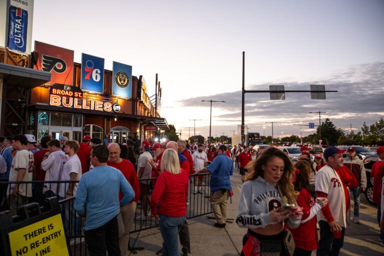 Fans wait in line to get into Xfinity Live to watch Game 4 of the Phillies playoff series game on October 12 2023. (Emily Cohen for WHYY)