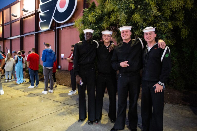Members of the Navy Ceremonial Guard, in from dc for Fleet Week, wait in line at Xfinity Live to watch Game 4 of the Phillies playoff series game on October 12 2023. (Emily Cohen for WHYY)
