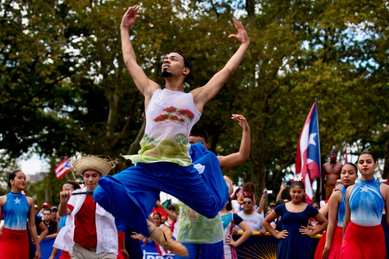 Eric Blanco leaps through the air during a dance performance as part of the Puerto Rican Day Parade