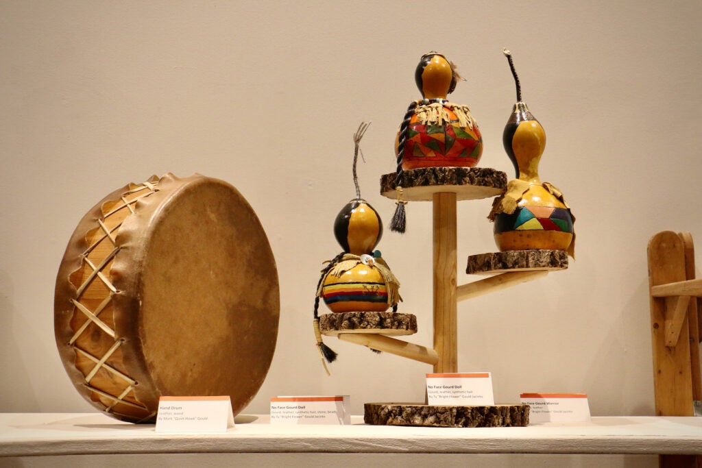 Traditional crafts, like a wood and leather hand drum and faceless gourd dolls are displayed in the church