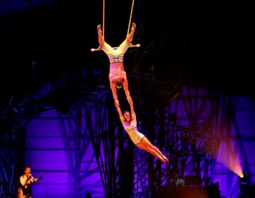 Trapeze artists perform in Cirque du Soleil's ''Bazzar'' at the Greater Philadelphia Expo Center in Oaks, Pa. (Emma Lee/WHYY)