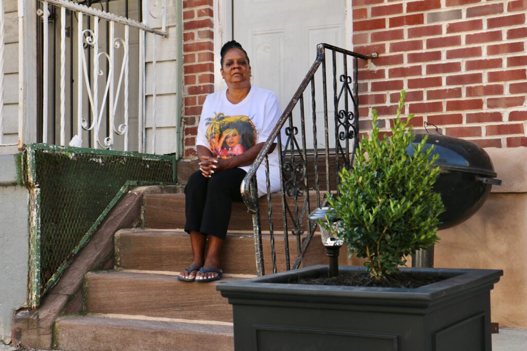 Vanity Rumph sitting in front of her house