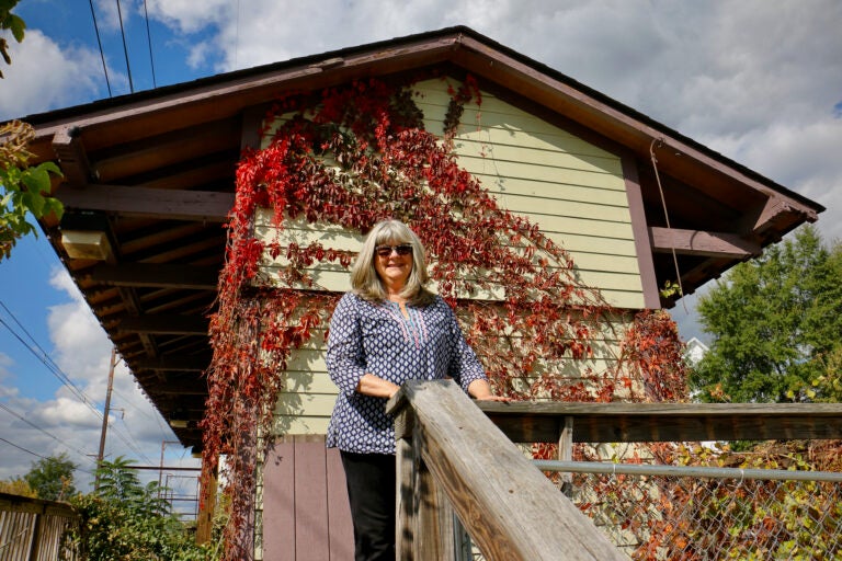 Bernadette Dougherty poses for a photo outside of the Ambler Freight House