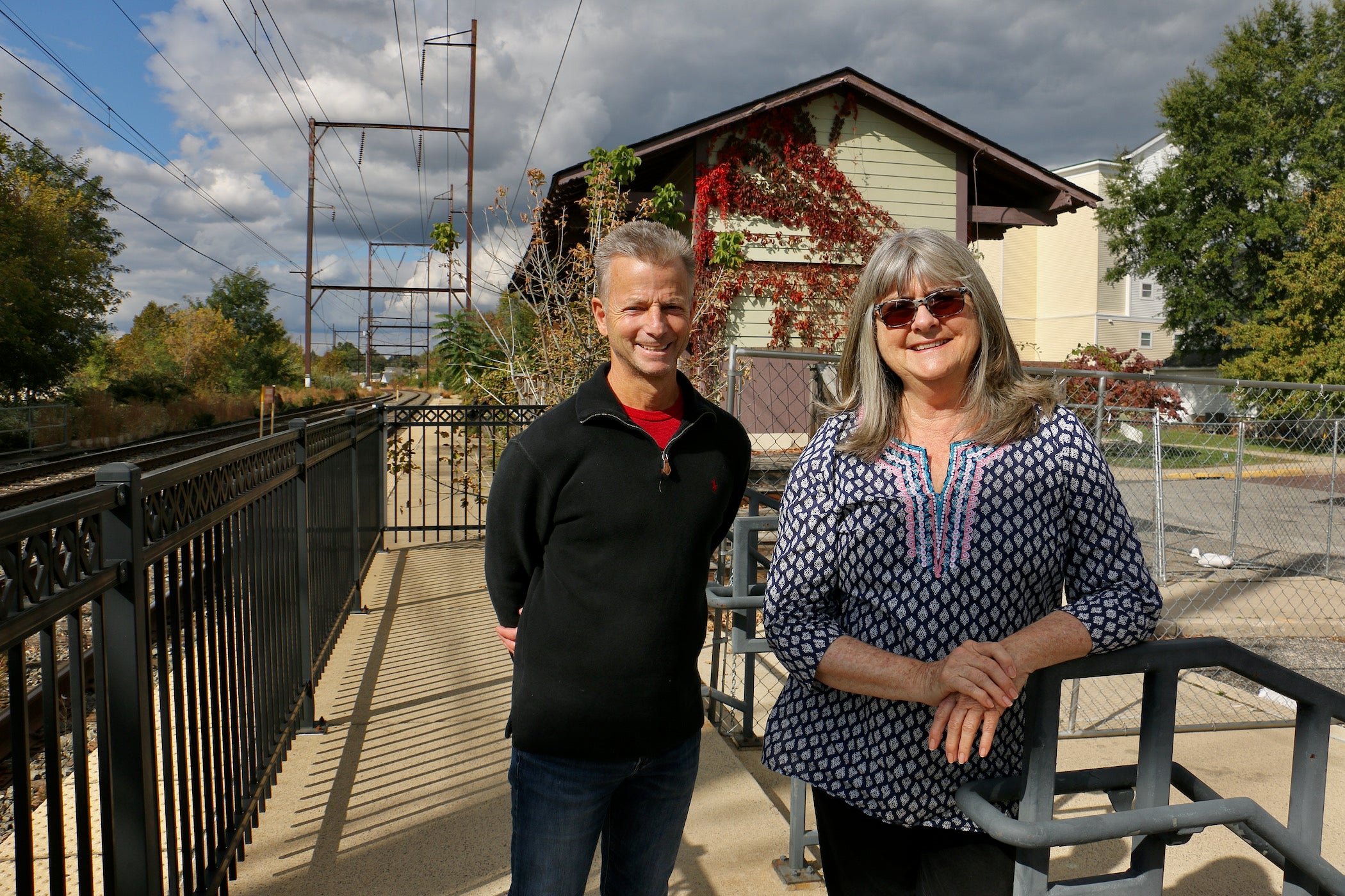 Joe Langella, vice president of the Wissahickon Valley Historical Society, and Bernadette Dougherty pose beside the Ambler Freight Station