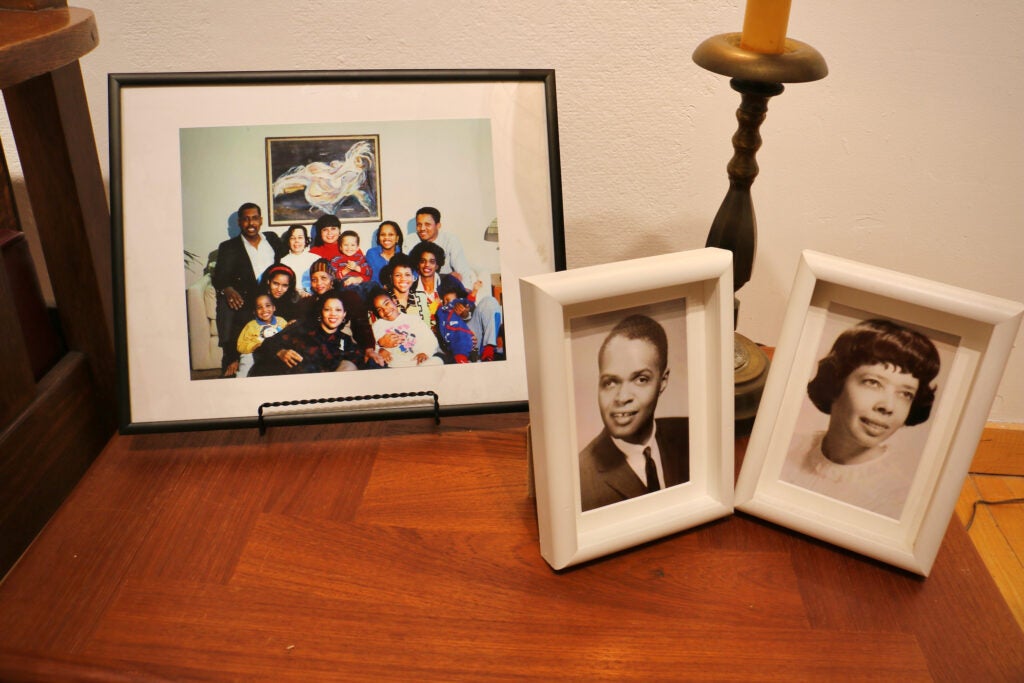 Photos of the Rollins McIntosh family are part of the Fleisher Art Museum exhibit on the life and work of Dox Thrash. At right are David and Esther Rollins McIntosh, who collected about 350 Dox Thrash works. At left is a photograph of Esther (back row, second from left) and her many nieces and nephews.