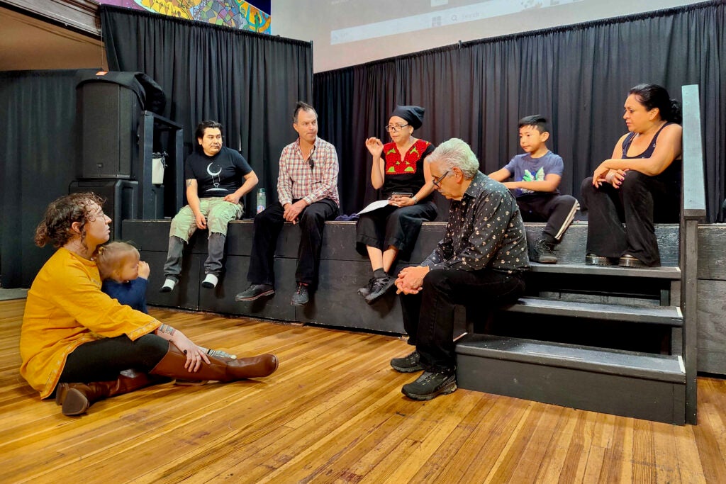 Brujo de la Mancha (far left on stage) with the cast of ‘’Camine, Camine, Camine, Pero Nunca Llegue,’’ listens to co-director Veronica Ponce de Leon.