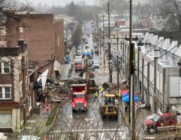 Emergency responders and heavy equipment are seen at the site of a deadly explosion at a chocolate factory in West Reading, Pennsylvania, Saturday, March 25.