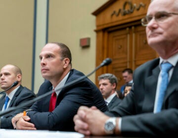 Ryan Graves, Americans for Safe Aerospace Executive Director, from left, U.S. Air Force (Ret.) Maj. David Grusch, and U.S. Navy (Ret.) Cmdr. David Fravor, testify before a House Oversight and Accountability subcommittee hearing on UFOs, Wednesday, July 26, 2023, on Capitol Hill in Washington. (AP Photo/Nathan Howard)