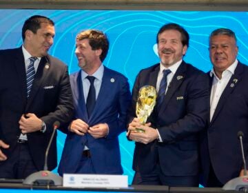 Paraguay's Soccer Association President Robert Harrison (left) FIFA delegate Ignacio Alonso, center, Conmebol President Alejandro Dominguez (third from left) and Conmebol Vice President Claudio Tapia stand after announcing host countries for the World Cup soccer tournament in Luque, Paraguay, Wednesday, Oct. 4, 2023.