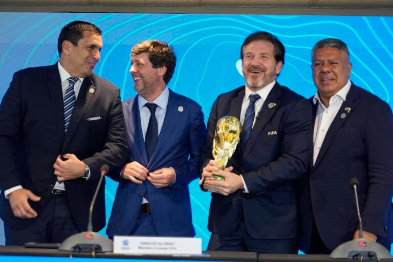 Paraguay's Soccer Association President Robert Harrison (left) FIFA delegate Ignacio Alonso, center, Conmebol President Alejandro Dominguez (third from left) and Conmebol Vice President Claudio Tapia stand after announcing host countries for the World Cup soccer tournament in Luque, Paraguay, Wednesday, Oct. 4, 2023.