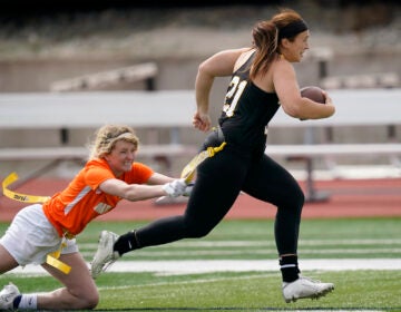 File photo: Ottawa quarterback Madysen Carrera (21) is tackled by Midland defender Casey Thompson (left) during an NAIA flag football game in Ottawa, Kan., March 26, 2021.