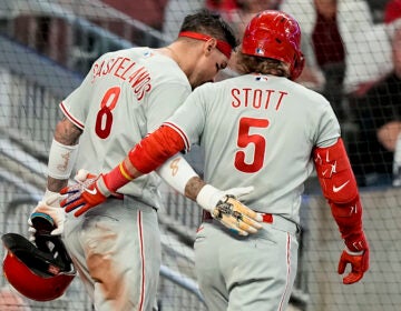 Philadelphia Phillies' Nick Castellanos (8) celebrates scoring a run with Bryson Stott (5) in the fifth inning of Game 2 of a baseball NL Division Series against the Atlanta Braves, Monday, Oct. 9, 2023, in Atlanta.