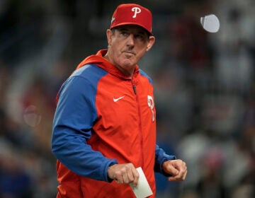 Philadelphia Phillies manager Rob Thomson walks back to the dugout after making a pitching change in the seventh inning of Game 2 of a baseball NL Division Series against the Atlanta Braves, Monday, Oct. 9, 2023, in Atlanta. (AP Photo/John Bazemore)