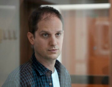 Wall Street Journal reporter Evan Gershkovich stands in a glass cage in a courtroom at the Moscow City Court in Moscow, Russia, Tuesday, Oct. 10, 2023.