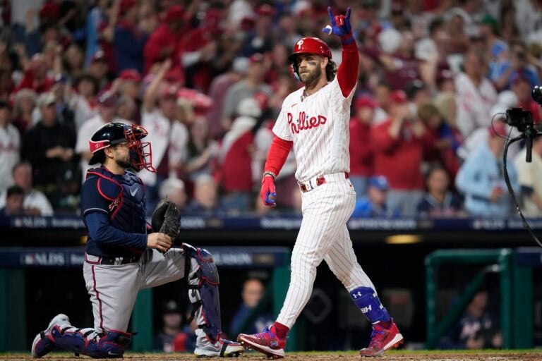Philadelphia Phillies' Bryce Harper reacts after hitting a home run