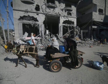 Palestinians leave their houses following Israeli airstrikes in Rafah refugee camp, southern Gaza Strip, Thursday, Oct. 12, 2023.