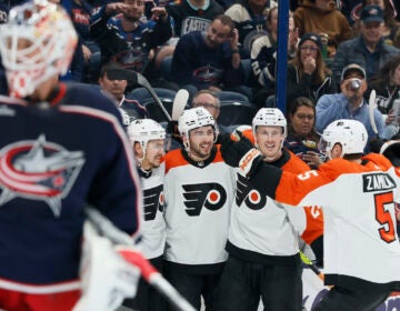 Philadelphia Flyers celebrate a goal against Columbus Blue Jackets' Elvis Merzlikins (foreground) during the first period of an NHL hockey game Thursday, Oct. 12, 2023, in Columbus, Ohio.