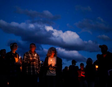 People gather at a vigil in Lisbon Falls, Maine, for victims of the week's mass shootings, Saturday, Oct. 28, 2023.