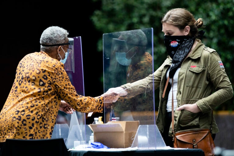 voter hands in her ballot