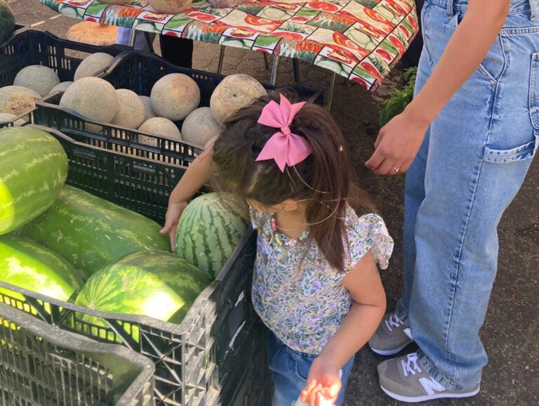 A mother and her daughter pick out produce at Everyone's Harvest market in Salinas. (Courtesy of Hester Parker)