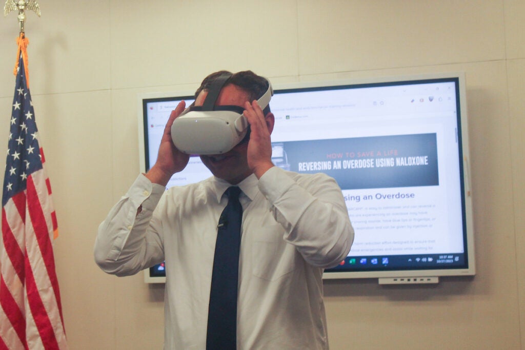 A volunteer looks through a VR viewfinder.