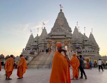 Monks walking in front of temple