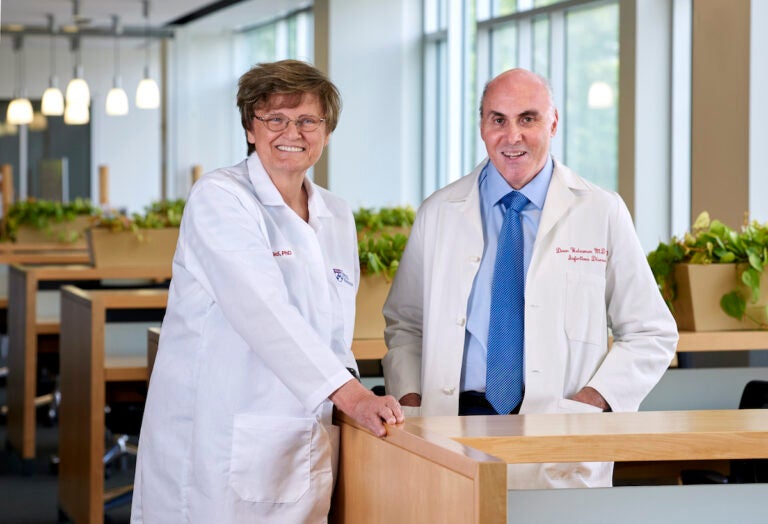 Closeup of Penn Medicine researchers Katalin Karikó Ph.D. and Dr. Drew Weisman Ph.D. in a Penn Medicine lab. (Peggy Peterson Photography courtesy Penn Medicine)