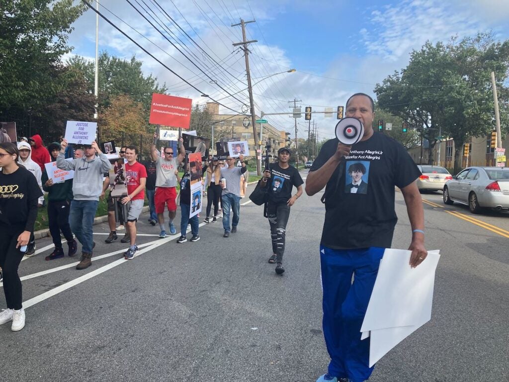 Terence Jones, an independent investigator who has been working with the Allegrini family, leads the crowd in a chant