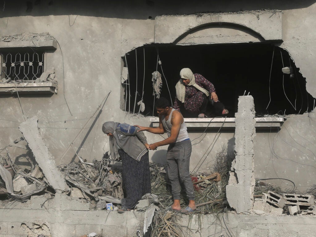 Palestinians evacuate a building damaged in the Israeli bombardment of the Gaza Strip in Rafah on Sunday.