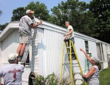 Workers repair a home