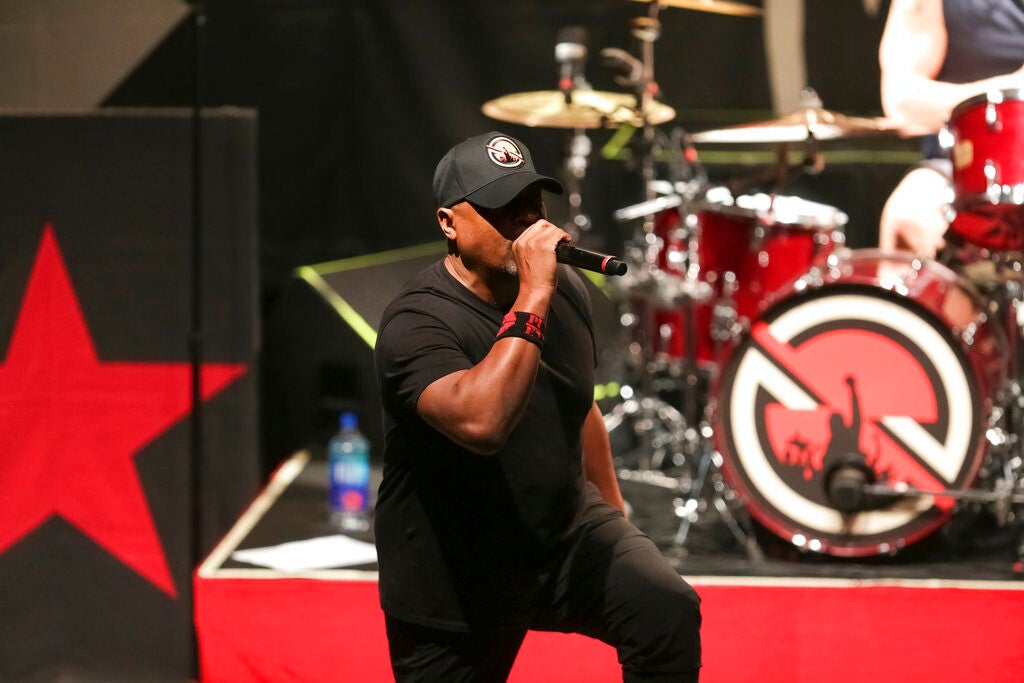 Chuck D sings into a microphone