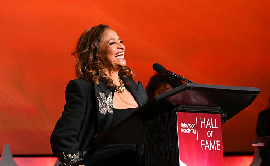 Debbie Allen speaks at a podium.