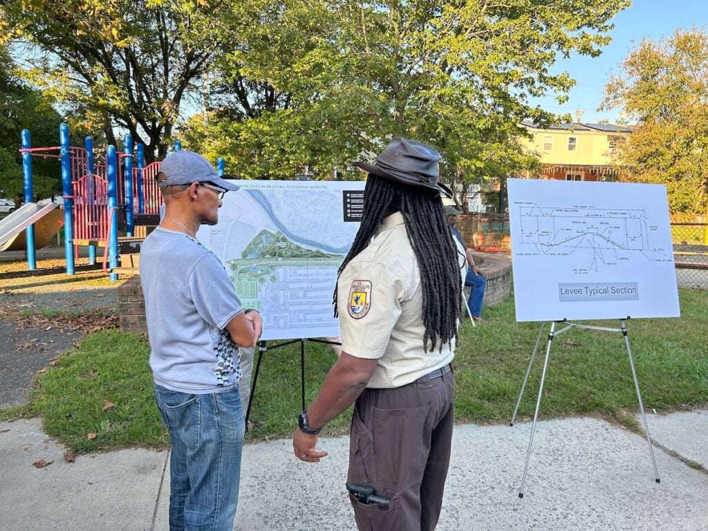 Eastwick residents and officials look at a proposal for a levee.