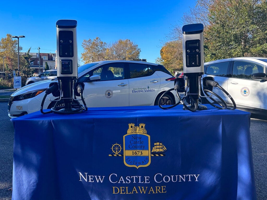 Electric vehicle plugs, with a sign for New Castle County.