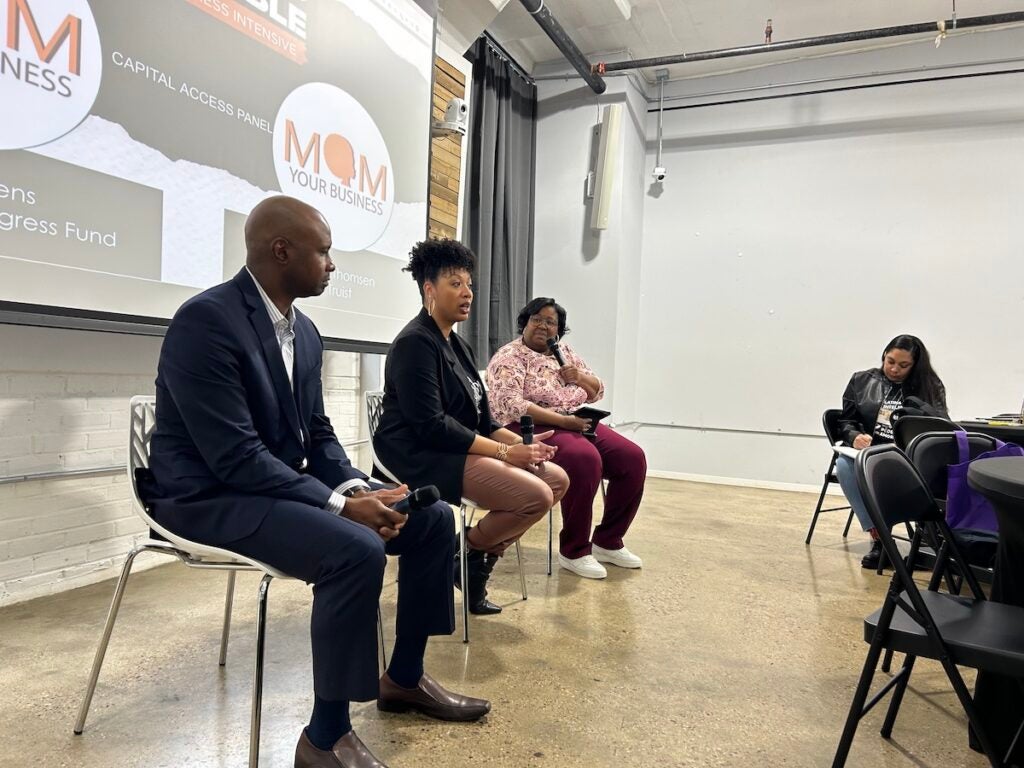 Reco Owens of the Neighborhood Progress Fund, Ryan Thompson of Truist Bank, and Tanya Morris of Mom Your Business (left to right) speak on a panel