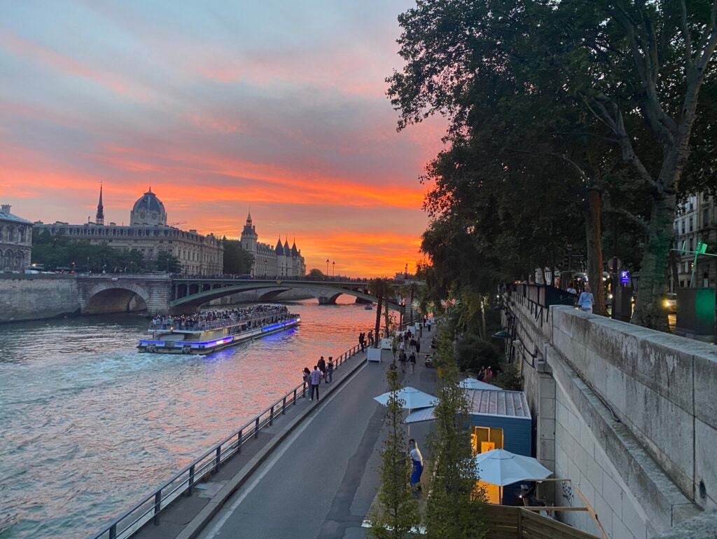 Along the Seine River in Paris, cars used to zoom by making noise and pollution. Now the city has converted some streets along the Seine into places for pedestrians and restaurants.