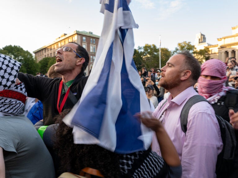 Protesters waving an Israeli flag