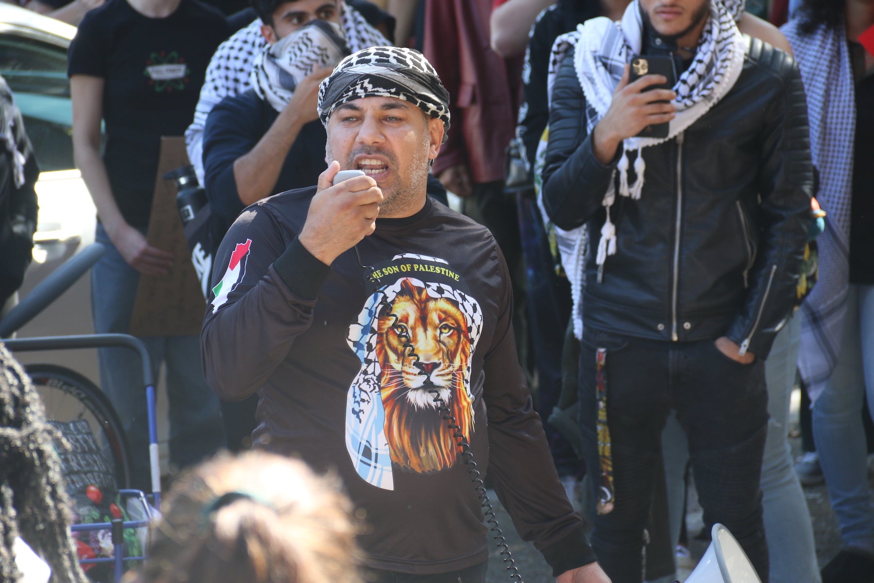 Rami Ibrahim speaking into a megaphone