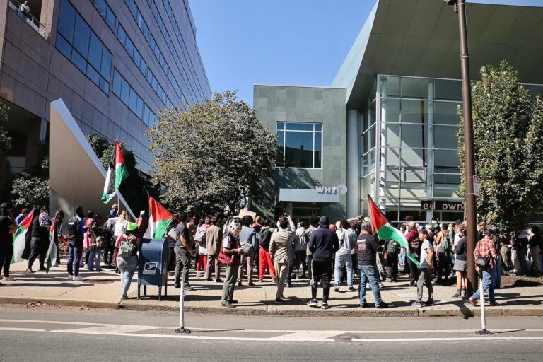 Protesters hold a rally in front of WHYY headquarters.