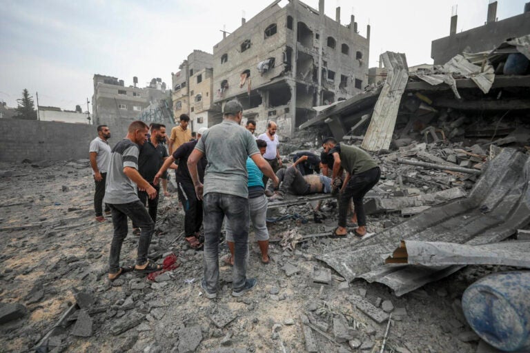 Palestinians evacuate the wounded following an Israeli aerial bombing on Jabaliya, near Gaza City, Wednesday, Oct.11, 2023