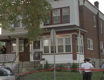 Police are seen outside a Lawncrest home following a triple homicide on Monday, Oct. 2, 2023.