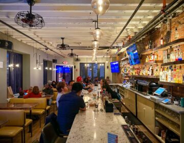 People sitting at the bar at a restaurant