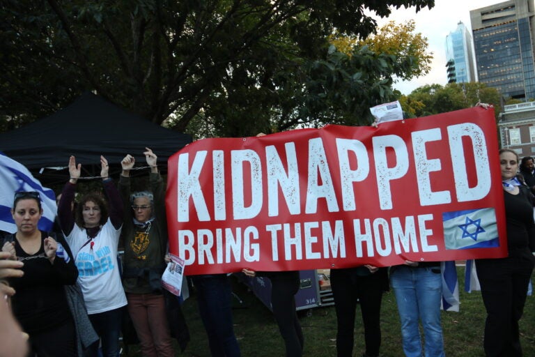 A sign at a march for Israel says ''Kidnapped. Bring them home.