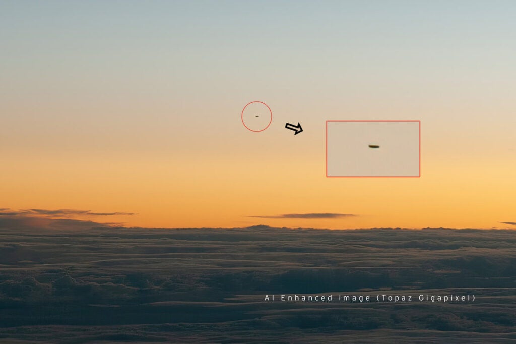 A small black flying object against an orange sunset. A red rectangle is around the object to point out its location. 