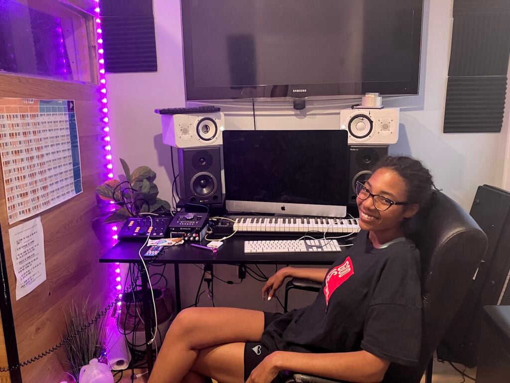 Nyjah Smith sitting in front of a recording console in the studio.