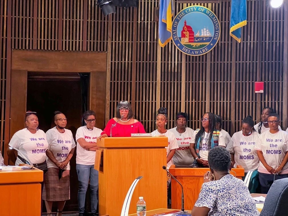 Zanthia Oliver speaking at a podium.