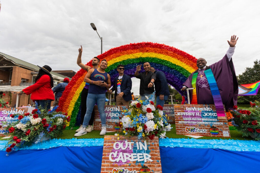 Business and community leaders wave from the Out in Career float at the OURfest National Coming Out Parade. (Daisie Cardona for Billy Penn)