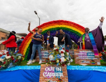 Business and community leaders wave from the Out in Career float at the OURfest National Coming Out Parade. (Daisie Cardona for Billy Penn)