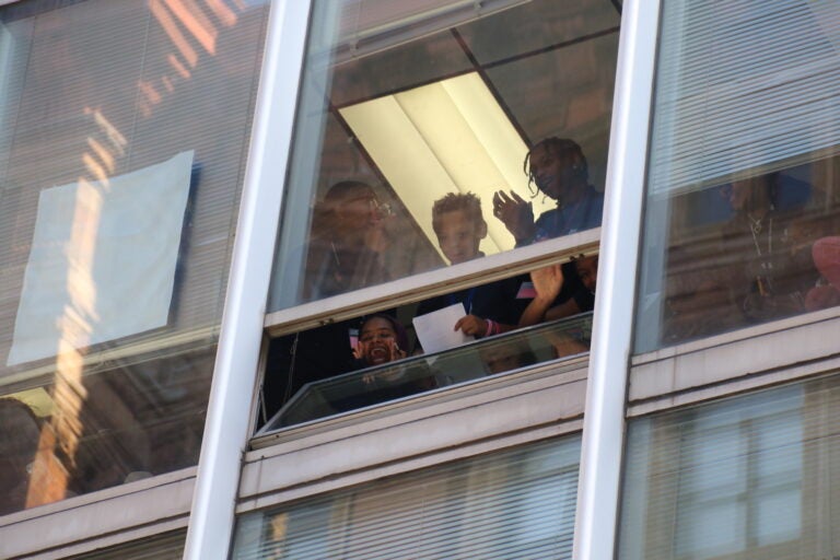 School kids waving from a window