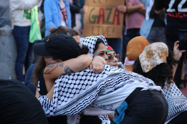 Two people hugging at the rally.